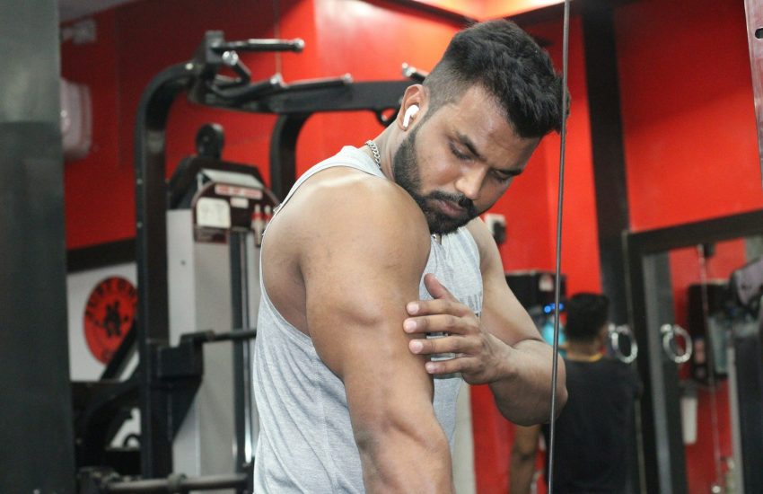 a man in a gym holding his hands together